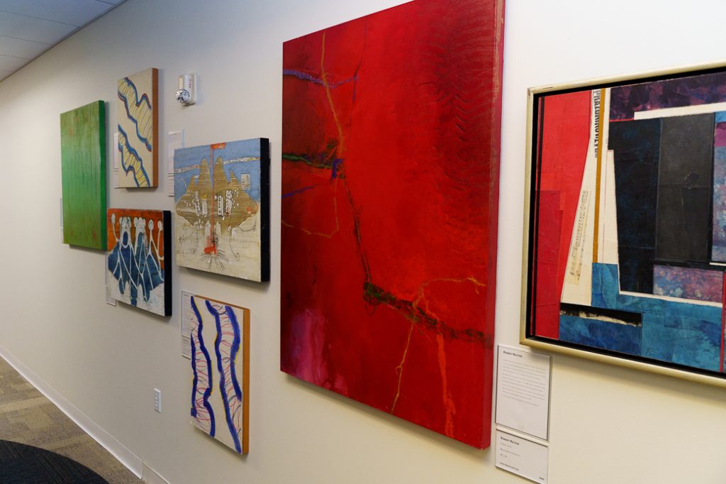 Different sizes abstract paints on a white wall